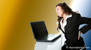 a person Augusta bending over a computer holding her back due to pain